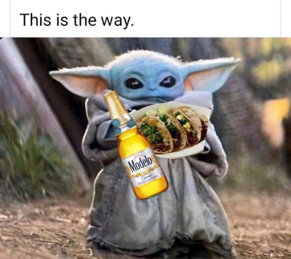 The meme is a photo of the character Yoda from the Star Wars franchise, holding a plate of tacos and a bottle of beer. The text "This is the way" is written above the image, which is a reference to Yoda's iconic phrase "When 900 years old you reach, look as good you will not" from the Star Wars movie "The Empire Strikes Back". The meme is a humorous twist on Yoda's phrase, suggesting that eating tacos and drinking beer is the way to a long and happy life.